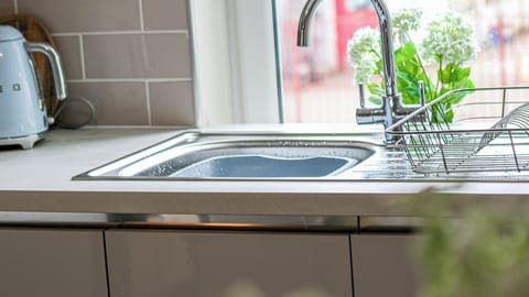 A clean and well-maintained kitchen sink designed for everyday convenience, making cooking and clean-up easy and stress-free during your stay.