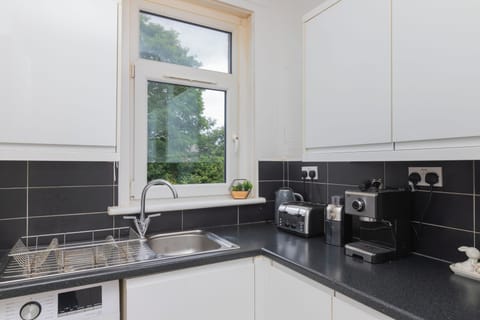 Cook, gather, and create memories in a modern kitchen featuring sleek appliances, ample storage, and a bright, airy layout.