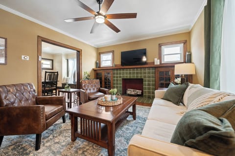 Main living area with plenty of seating options, natural light, fireplace, and smart TV.