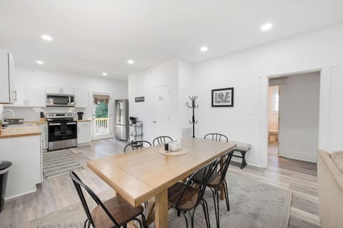 Large dining table for 6 with a bench on the six for extra seating.