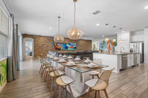 - Elegant dining area with seating for large gatherings  
- Open concept with modern kitchen and pendant lighting  
- Orlando vacation home ideal for families and group stays