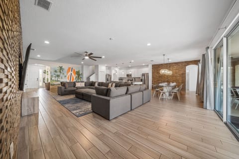 - Modern open floor plan with large sectional for relaxing  
- Spacious kitchen and dining setup for family gatherings  
- Orlando group vacation rental with stylish comfortable design