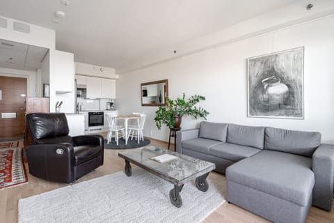The bright and cozy living room offers the perfect space to relax after a day of exploring. It features an efficient air cooler to keep the temperature comfortable even on warm days. From the living room, you have direct access to a private balcony — perf