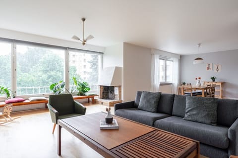 Relax in the spacious living area, which features large windows that flood the space with natural light throughout the day.