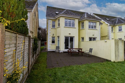Aughrim Holiday Village No. 14. Aughrim holiday village. Rear with patio outside dining and garden.