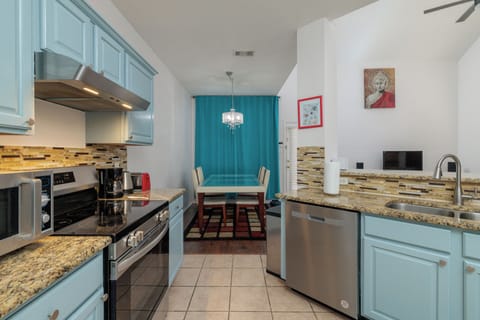 Fully stocked kitchen, 2 bar top stools, and laundry closet.