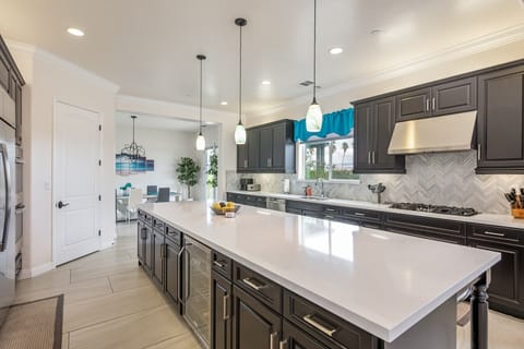 Spacious kitchen loaded with lots of appliances and supplies