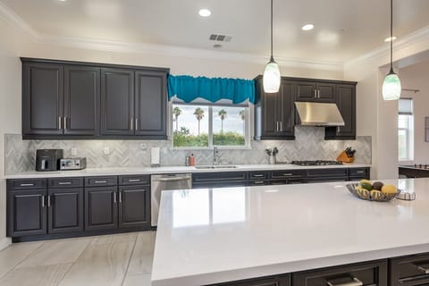 Spacious kitchen loaded with lots of appliances and supplies