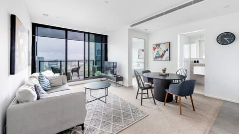  Bright and stylish living room with floor-to-ceiling windows and city views.
