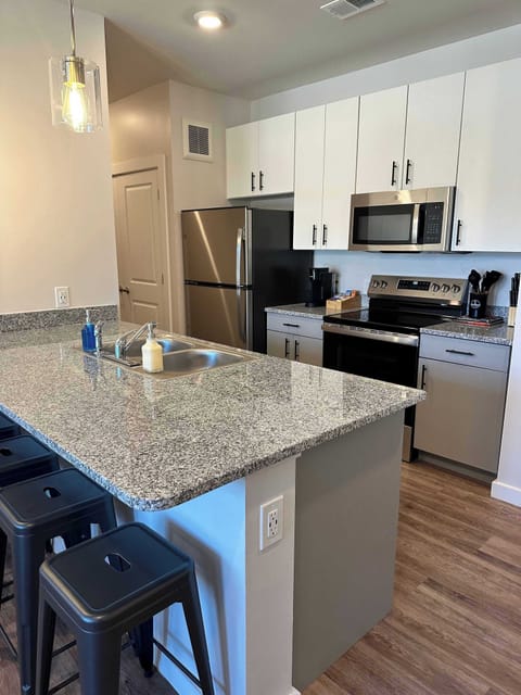 Modern Kitchen & Breakfast Bar – Enjoy a fully equipped kitchen with stainless steel appliances, sleek granite countertops, and a spacious island with bar seating—perfect for dining, working, or entertaining!
