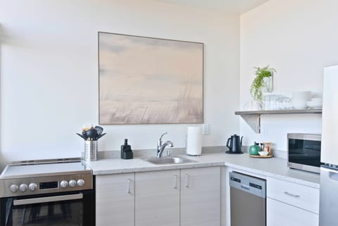 Enjoy cooking in this sleek, modern kitchen with all essentials provided.