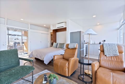 A bright and airy studio featuring a sleek Murphy bed