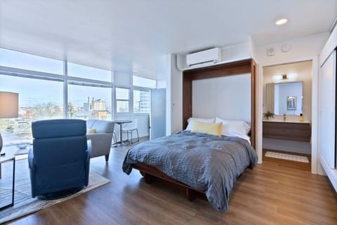 A bright and airy studio featuring a sleek Murphy bed