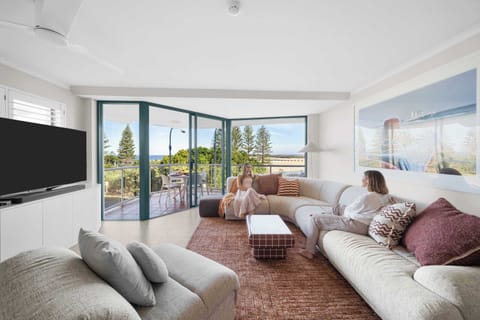 Wake up to breathtaking beachfront views from this beautifully styled coastal apartment