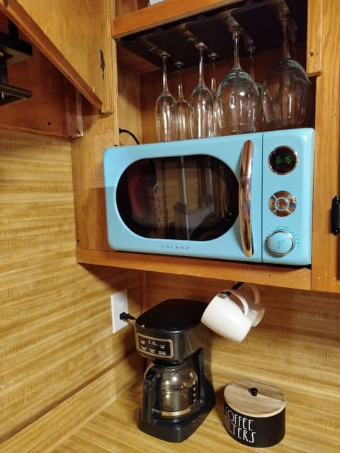 Unique blue microwave with chrome fittings in kitchen