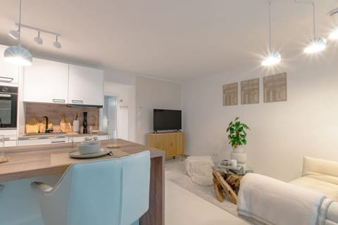 A view of the open kitchen, dining area, and living area.