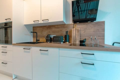 The fully equipped kitchen with modern appliances.