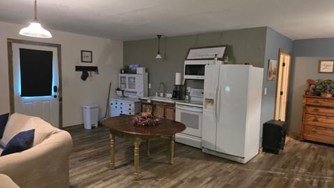 Kitchen showing front door on left and bathroom door on right.