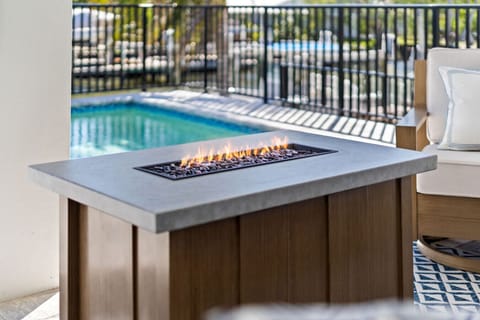 Evenings made perfect with poolside seating and a cozy fire table