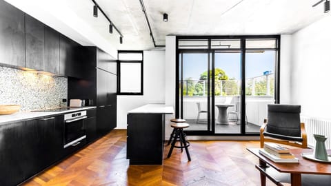 Sleek designer kitchen with sunlit interiors and private balcony access.