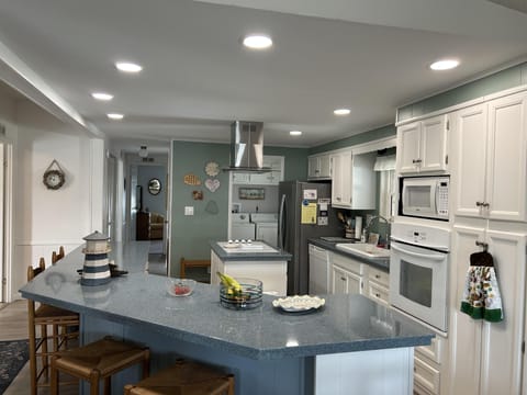 Spacious kitchen with modern appliances and cozy breakfast bar