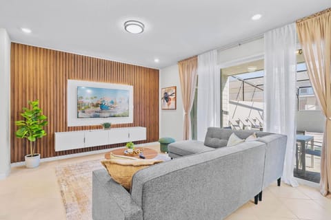 Bright Living Room with Smart TV and Pool Access