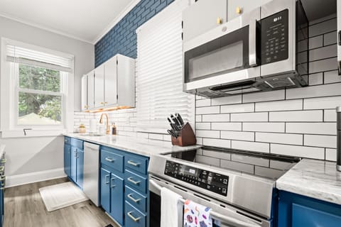 Clean and Modern, this kitchen has views in every direction and a rich, beautiful brick seen throughout the room.