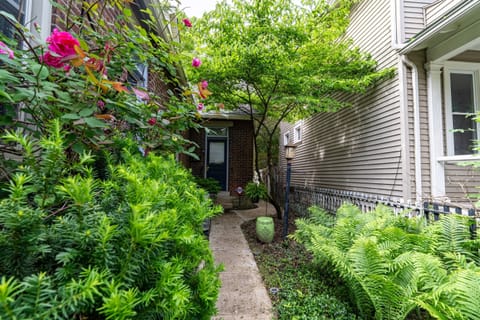 Beautiful and unique entryway with planter boxes, flowers, bird feeders, and more.