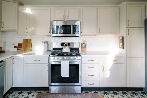 Stainless steel appliances and fully stocked kitchen