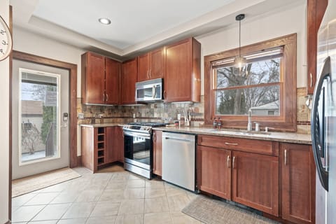 Your fully equipped kitchen features warm cherry cabinets, granite counters, and stainless appliances for effortless meal prep.