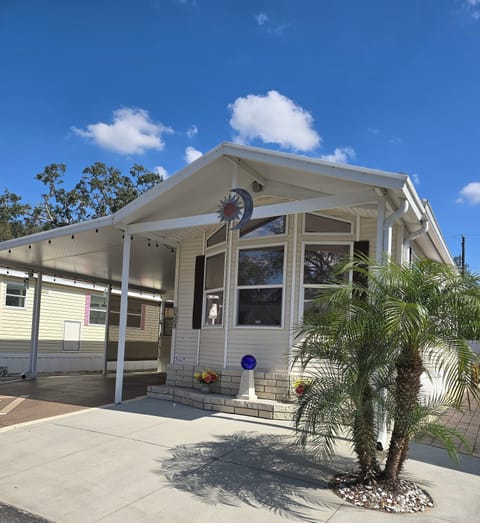 Front exterior with extra wide carport