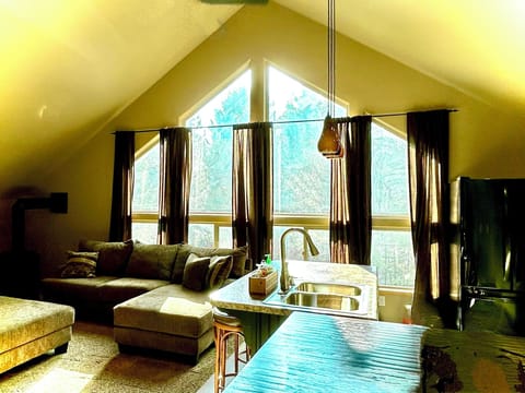 Relax in the open living room as sunshine wanders in with the large windows. 