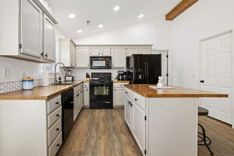 Whether you're preparing delicious meals in the fully equipped kitchen or enjoying a card game at the dining table, the seamless flow of this space ensures everyone can be part of the fun.