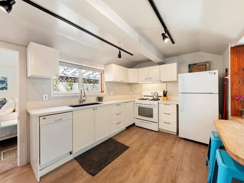 The airy kitchen offers ample space & all the comforts of home