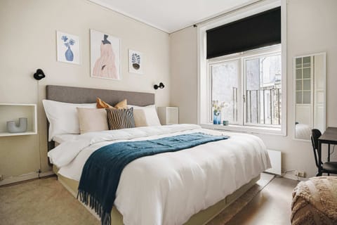 Sunlit bedroom with modern decor and an inviting bed setup