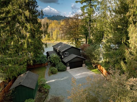 Private fenced yard and driveway with serene river views.