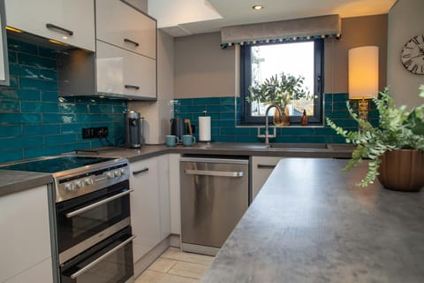 Kitchen area with electric cooker, dishwasher and large island unit