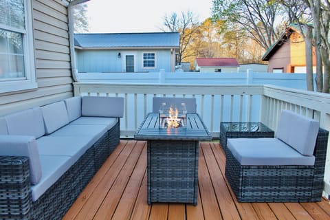 Outdoor furniture on the back deck with a fire table