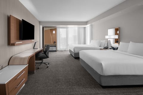 Unwind in a bright double-queen room with work desk.