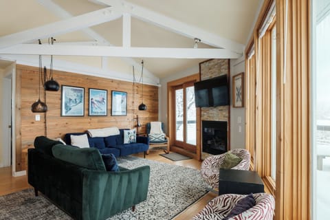 Warm up by the gas fireplace and watch skiers pass by through large windows overlooking the slopes. The inviting living area blends comfort and character for true mountain relaxation.