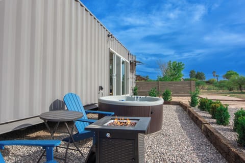 Outdoor hangout area with fire pit, hot tub, and BBQ