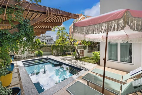 Pool with comfortable tanning beds, enjoy refreshing drinks under the shade of the stylish umbrella, 