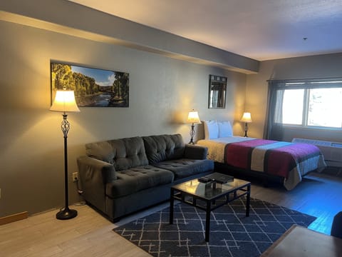 Relax in your spacious suite where comfort meets style—sink into the plush sofa after a day of exploring, or unwind on your cozy bed with soft lighting creating the perfect ambiance for your getaway.