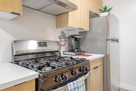 A close-up of the sleek, modern gas stove, perfect for cooking your meals.