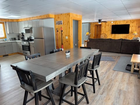 Large Dining room with seating for 6 with views of the kitchen and living room.
