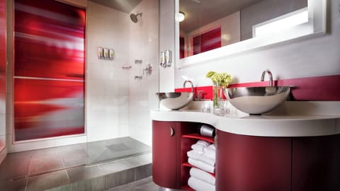 Indulge in a sleek bath space with designer double sinks.