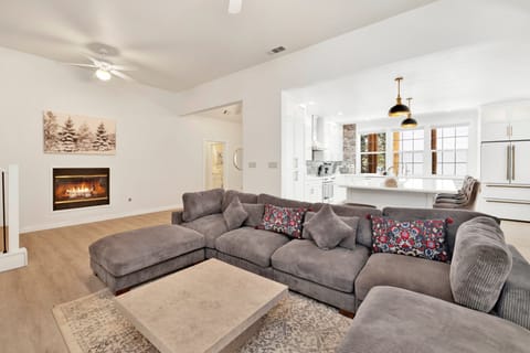 Cozy mountain living room with a fireplace, comfy seating, and smart TV—perfect for relaxing evenings, movie nights, and warm cabin vibes after outdoor adventures.