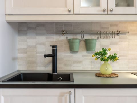 Flooring, Interior Design, Countertop, Floor, Kitchen, Furniture, Tap, Sink, Plumbing Fixture, Cabinetry