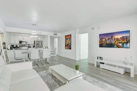 Modern and well decorated living space with a cozy pull out sofa bed. Large glass sliding door revealing the gorgeous city and abundance of natural light.