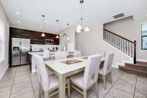 Gather around the spacious dining table, perfect for enjoying meals and making memories.